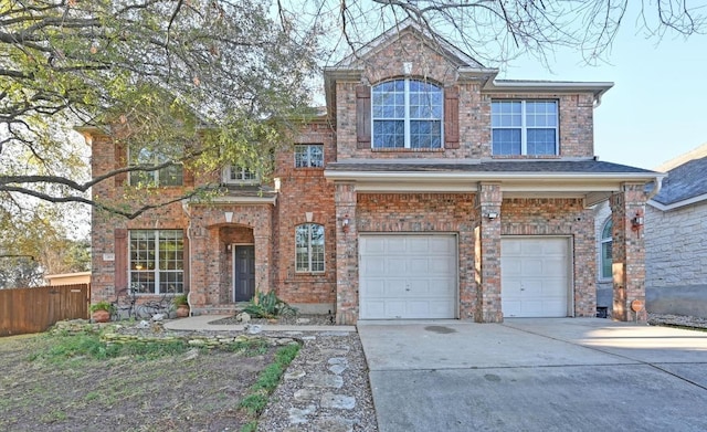 view of front of property featuring brick siding, fence, a garage, and driveway