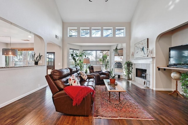 living room with hardwood / wood-style floors, a healthy amount of sunlight, and visible vents