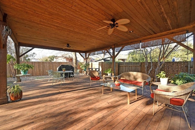 deck featuring ceiling fan, outdoor dining area, an outdoor living space, and a fenced backyard