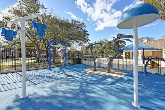 view of property's community with playground community and fence