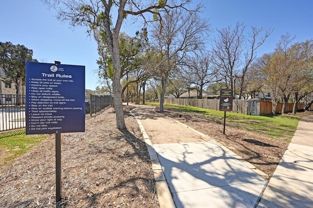 view of home's community featuring fence