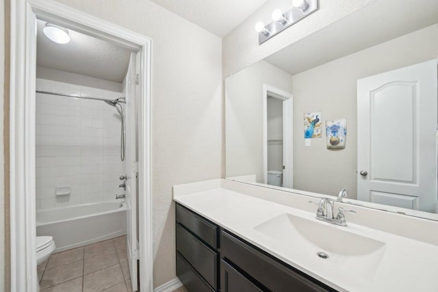 full bathroom featuring vanity, washtub / shower combination, a textured ceiling, tile patterned floors, and toilet