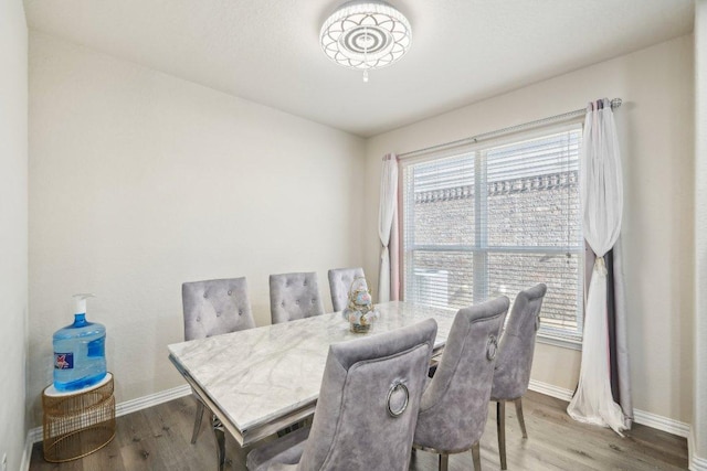 dining room featuring baseboards and wood finished floors