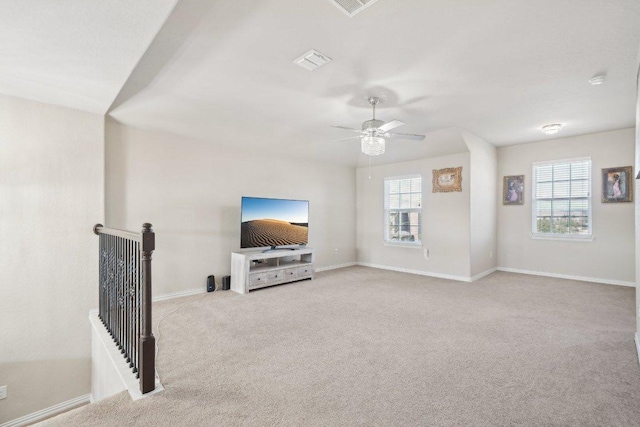 carpeted living area featuring visible vents, baseboards, and ceiling fan