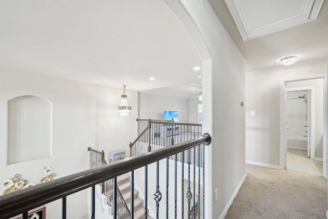 hall with baseboards, attic access, an upstairs landing, light carpet, and recessed lighting