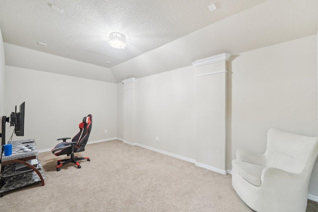 office featuring decorative columns, carpet floors, a textured ceiling, and lofted ceiling