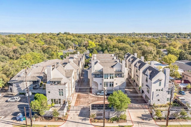 birds eye view of property featuring a view of trees