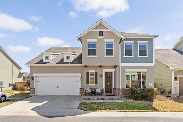 view of front of property featuring roof with shingles, driveway, an attached garage, stucco siding, and brick siding