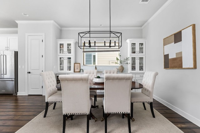 5820 Harper Park Dr Unit 70, Austin, TX 78735 - dining area featuring a chandelier, crown molding, dark wood-type flooring, and recessed lighting
