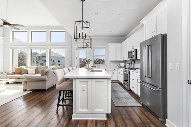 5820 Harper Park Dr Unit 70, Austin, TX 78735 - kitchen featuring high end appliances, open floor plan, a ceiling fan, a chandelier, and dark wood-style floors