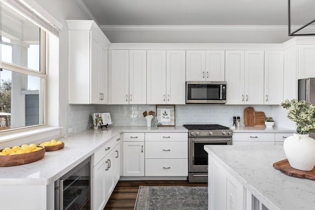 5820 Harper Park Dr Unit 70, Austin, TX 78735 - kitchen with appliances with stainless steel finishes, beverage cooler, white cabinets, crown molding, and dark wood-type flooring