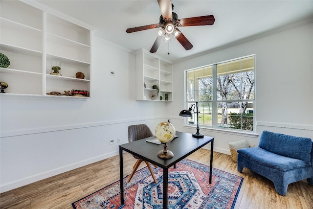 home office with baseboards, wood finished floors, a ceiling fan, and ornamental molding