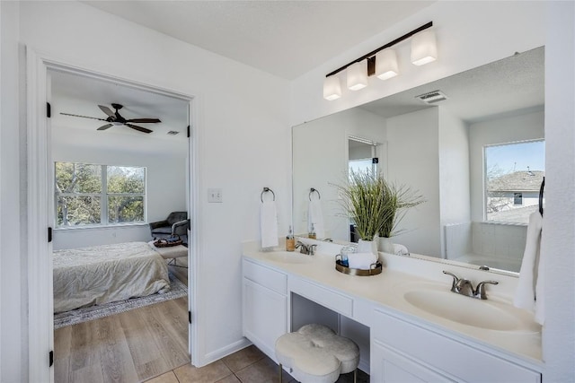 full bath featuring double vanity, visible vents, tile patterned floors, and a sink