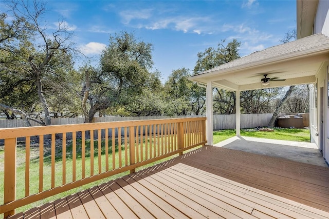 wooden deck with a yard, a fenced backyard, and ceiling fan