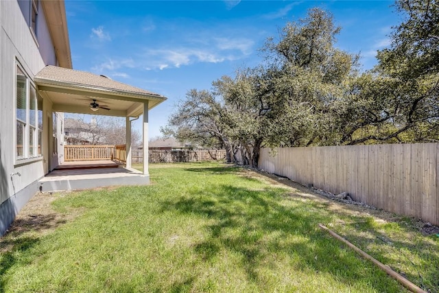 view of yard with a ceiling fan and a fenced backyard