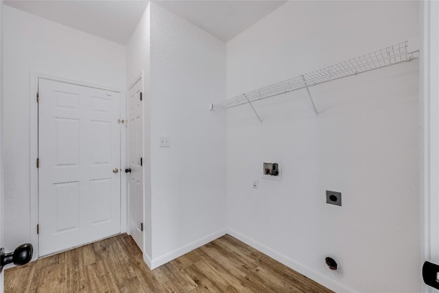 laundry room featuring light wood finished floors, baseboards, laundry area, hookup for a washing machine, and electric dryer hookup