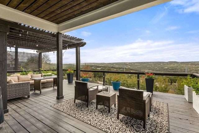 deck featuring an outdoor hangout area and a pergola