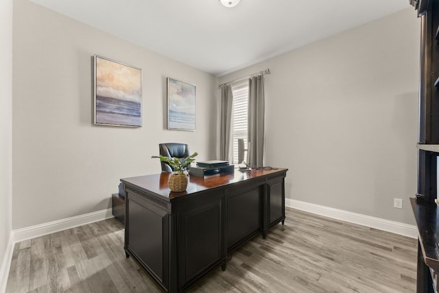 office space with light wood-style flooring and baseboards