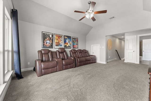 carpeted cinema featuring visible vents, ceiling fan, baseboards, and vaulted ceiling