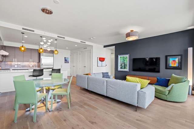 living room featuring visible vents and light wood-type flooring