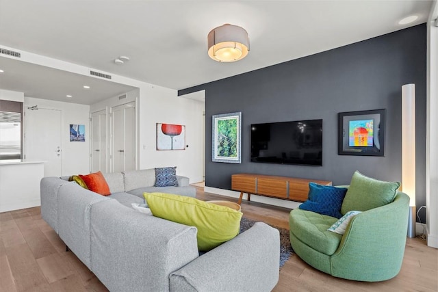 living room featuring wood finished floors and visible vents