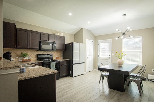 kitchen featuring backsplash, dark brown cabinets, lofted ceiling, black appliances, and a sink