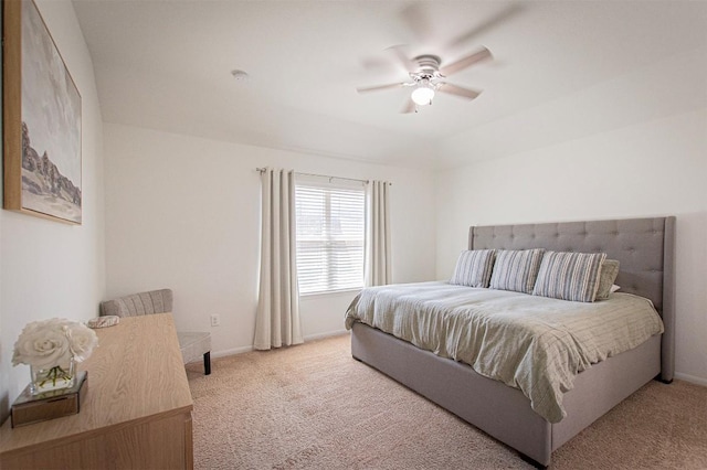 bedroom featuring ceiling fan, baseboards, and light carpet