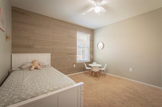 unfurnished bedroom featuring baseboards, light carpet, and ceiling fan