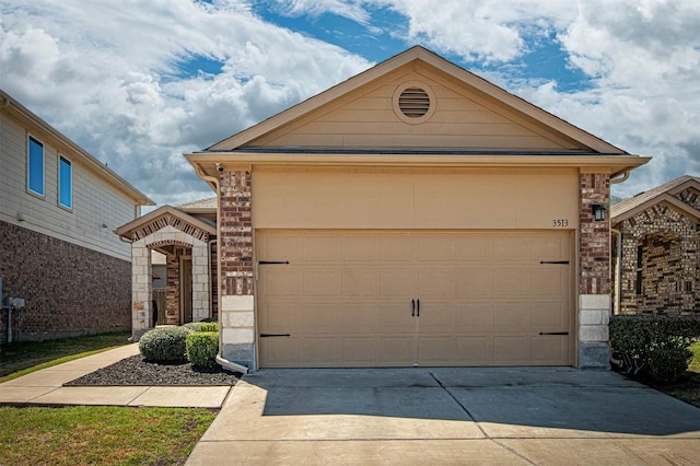 ranch-style house with a garage, brick siding, and driveway