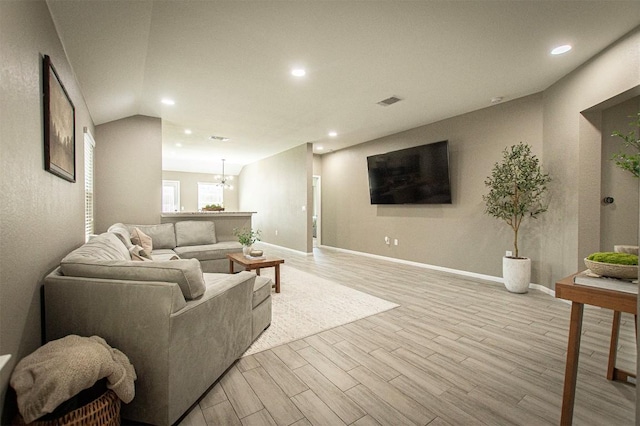 living room with visible vents, baseboards, an inviting chandelier, recessed lighting, and light wood-type flooring