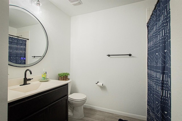 full bathroom featuring visible vents, baseboards, toilet, wood finished floors, and vanity