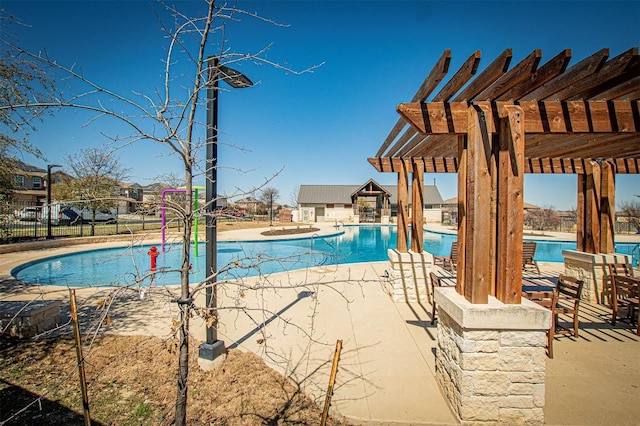 community pool featuring an outbuilding, fence, a patio area, and a pergola