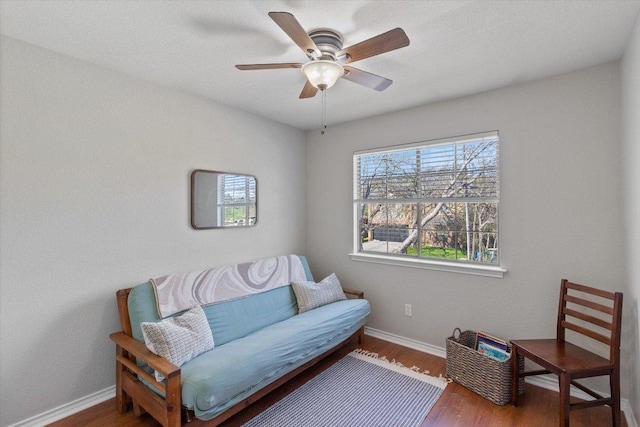 sitting room with wood finished floors, baseboards, and ceiling fan