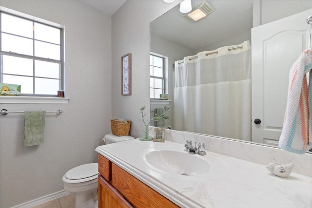 bathroom with tile patterned flooring, visible vents, baseboards, toilet, and vanity