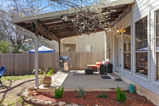 view of patio / terrace featuring fence and a grill