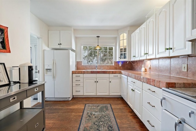 kitchen featuring dark wood finished floors, white appliances, white cabinetry, and backsplash