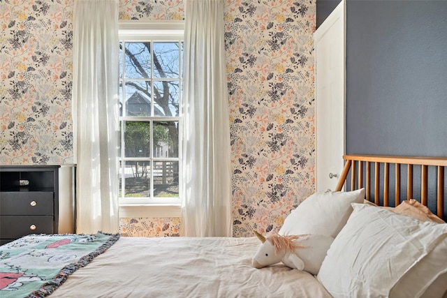 bedroom featuring multiple windows and wallpapered walls