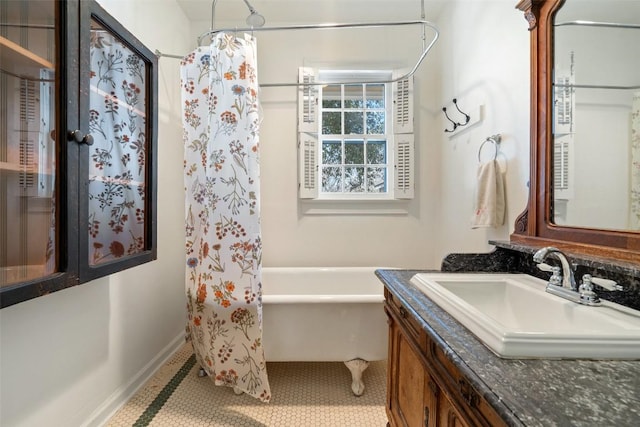 bathroom with vanity, a shower with curtain, baseboards, tile patterned floors, and a washtub