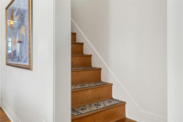 5902 Coventry Ln, Austin, TX 78723 - stairs with baseboards and wood finished floors