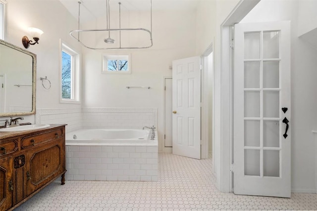 full bath featuring vanity and a garden tub