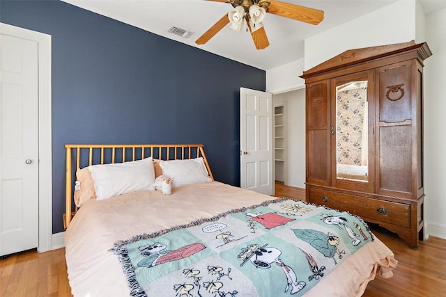 5902 Coventry Ln, Austin, TX 78723 - bedroom with wood finished floors and ceiling fan