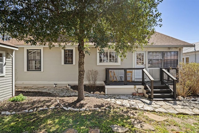 rear view of house with a shingled roof