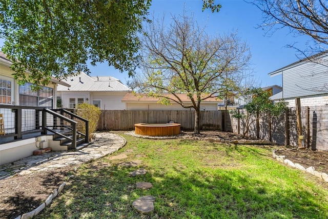 view of yard featuring a fenced backyard and a hot tub