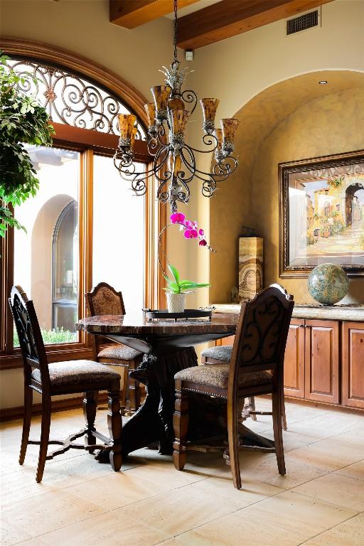 dining area featuring visible vents and a chandelier