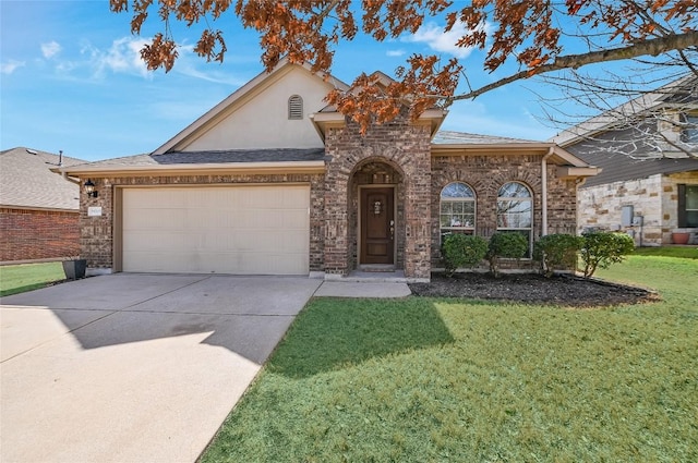 view of front of home with driveway, stucco siding, a front lawn, a garage, and brick siding