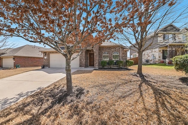 view of front of property featuring brick siding, a garage, and driveway