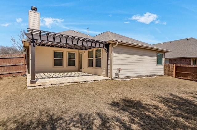 rear view of house with a chimney, a patio, a pergola, and a fenced backyard