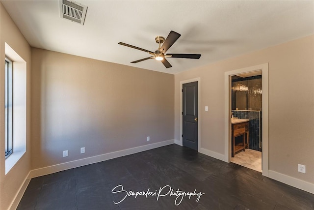 unfurnished bedroom with ceiling fan, visible vents, baseboards, and ensuite bath