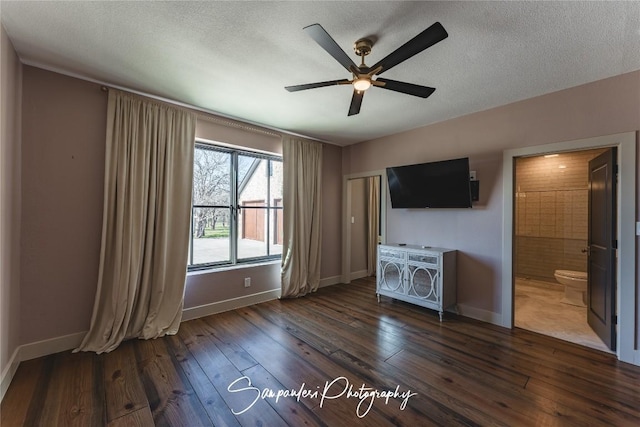 unfurnished living room featuring baseboards, a textured ceiling, dark wood finished floors, and a ceiling fan