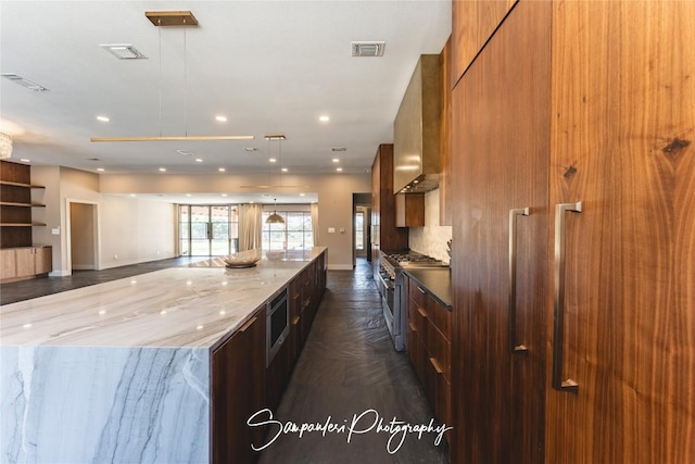 kitchen with visible vents, recessed lighting, stainless steel appliances, wall chimney exhaust hood, and modern cabinets